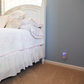 Pest Repeller Ultimate® AT plugged into an outlet in the bedroom